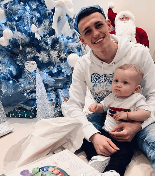 Phil Foden With Son Twining In White